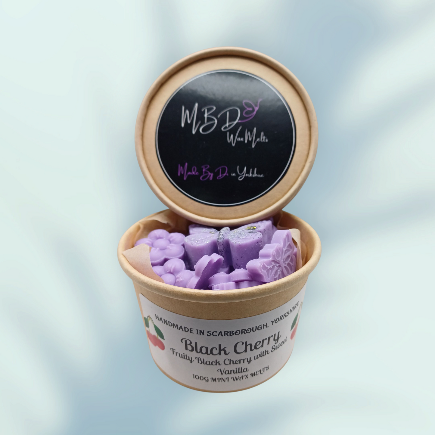 Black Cherry Mini Wax Melt scoopies in an open tub
