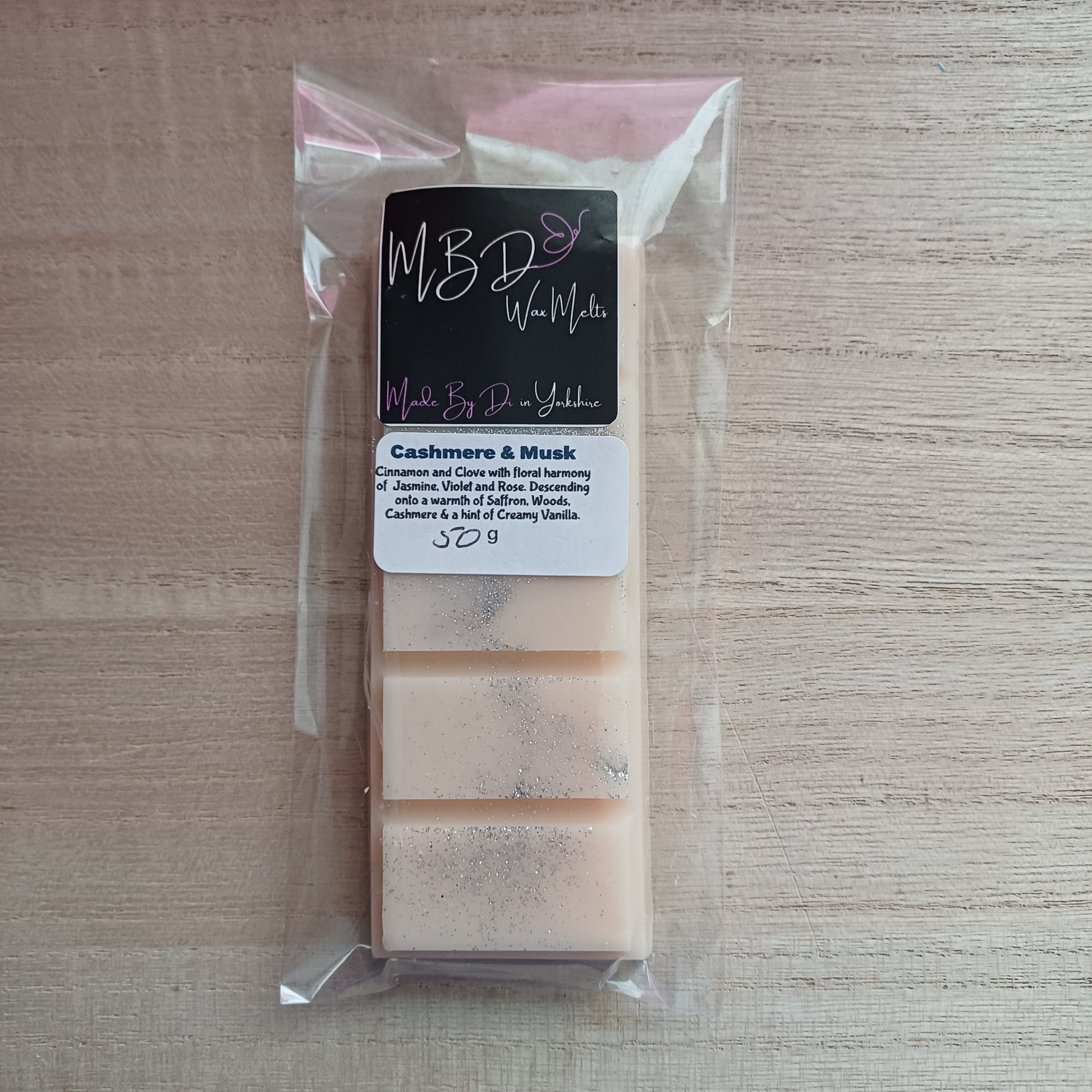 Packaged Wax melts on a wooden background.