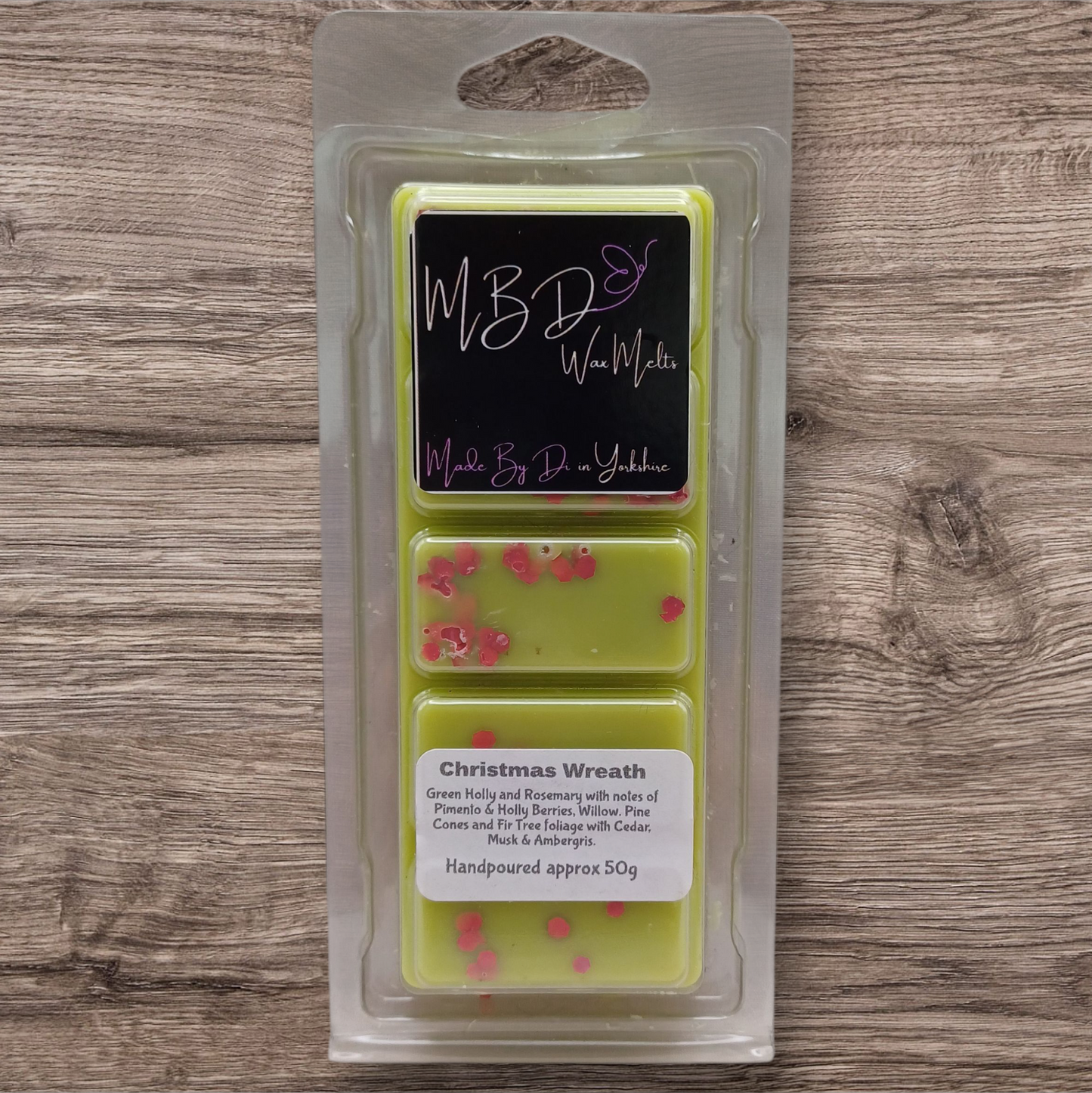 Packaged wax melts with 'MBD Wax Melts' branding on a wooden surface