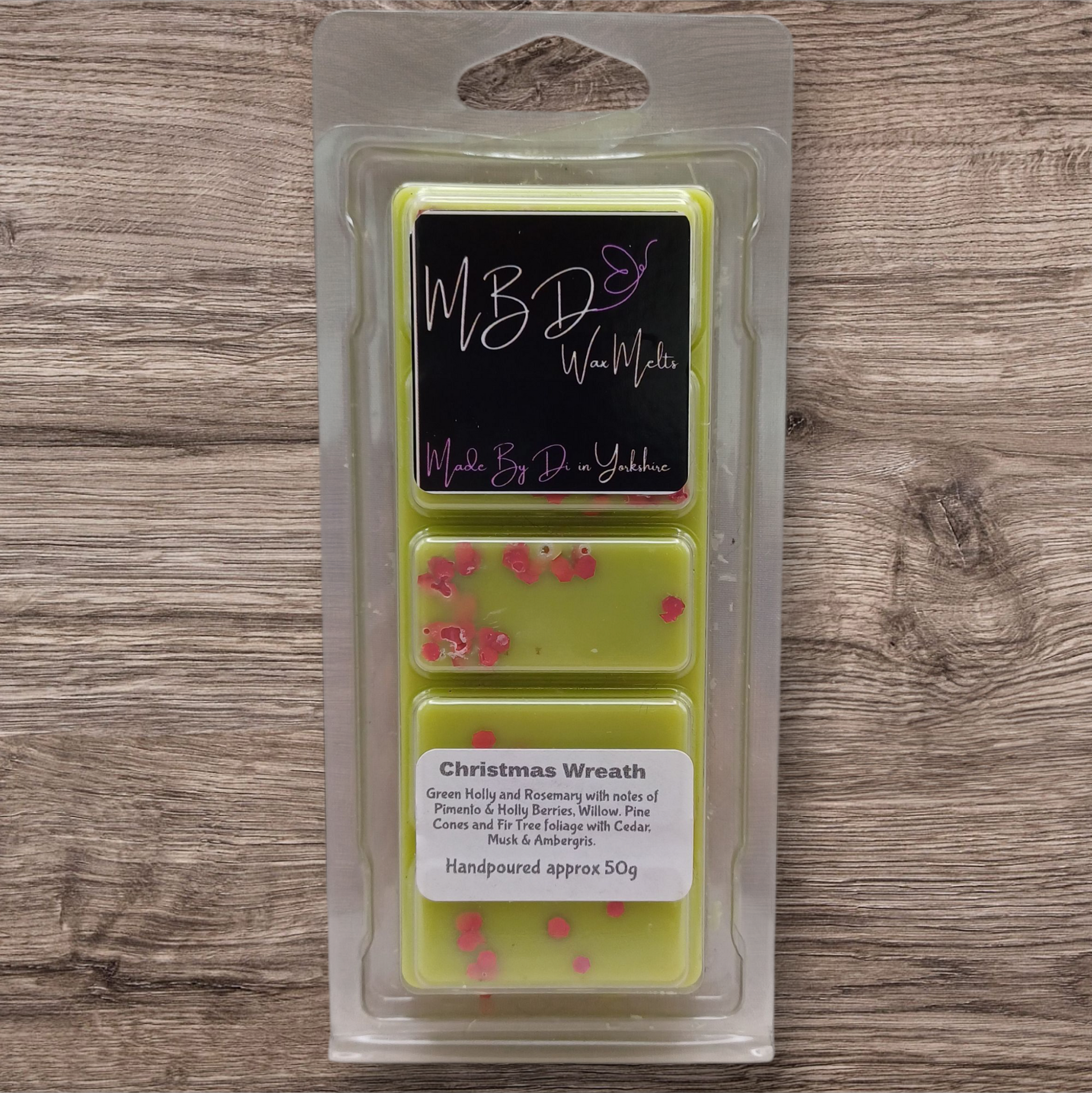 Packaged wax melts with 'MBD Wax Melts' branding on a wooden surface