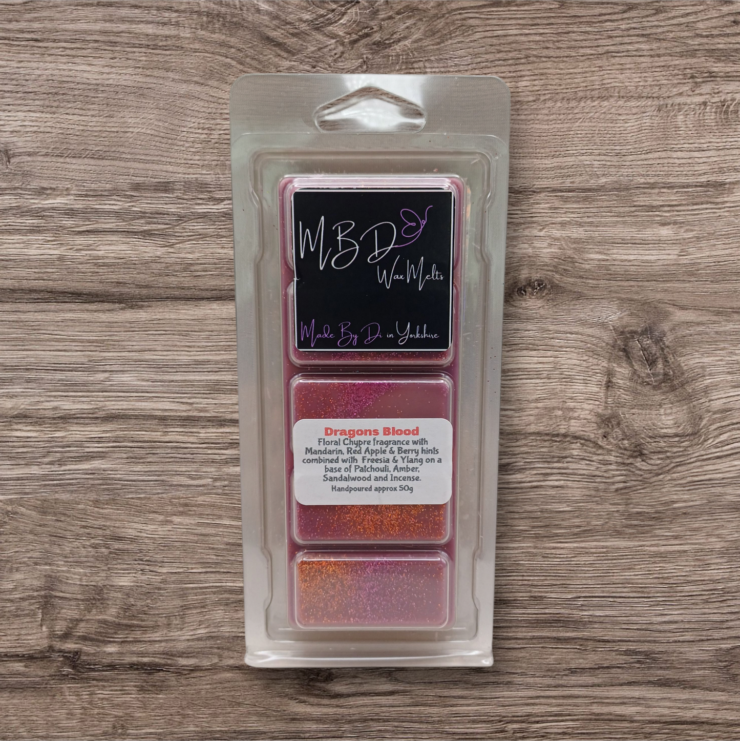 Packaged wax melts with visible branding on a wooden surface