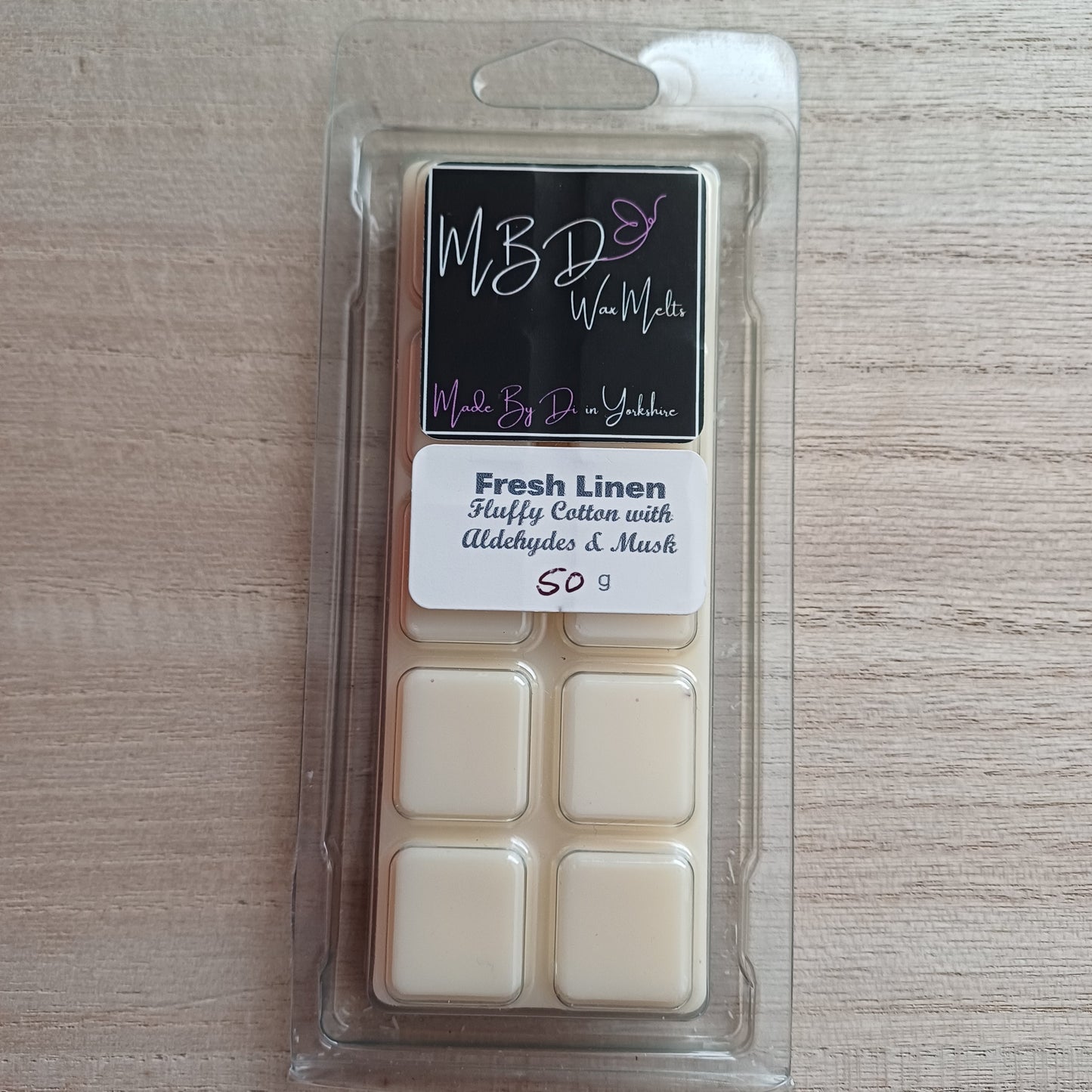 Packaged Wax Melts with MBD Branding on a wooden surface