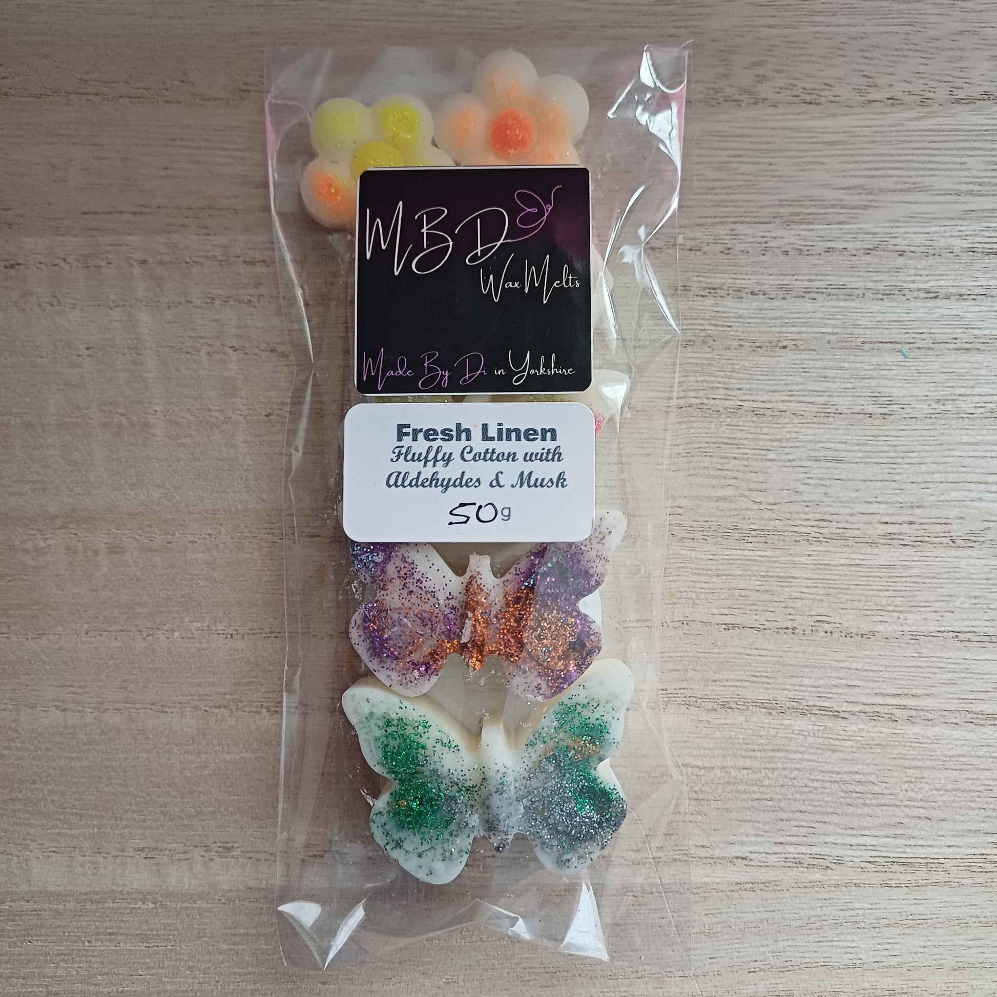 Packaged Decorative Butterfly Shaped Wax Melts on a wooden Surface