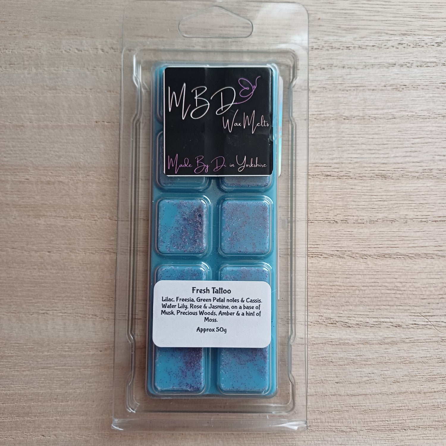 Packaged wax melts with MBD label on a wooden Surface