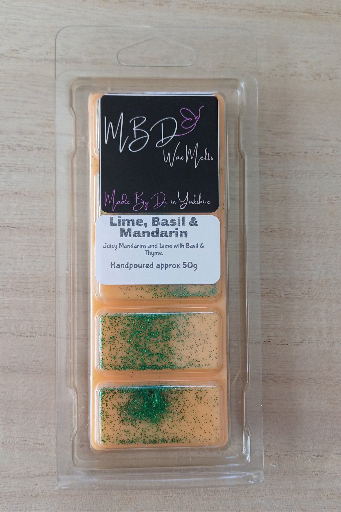 Wax Melt in a clear package on a wooden surface