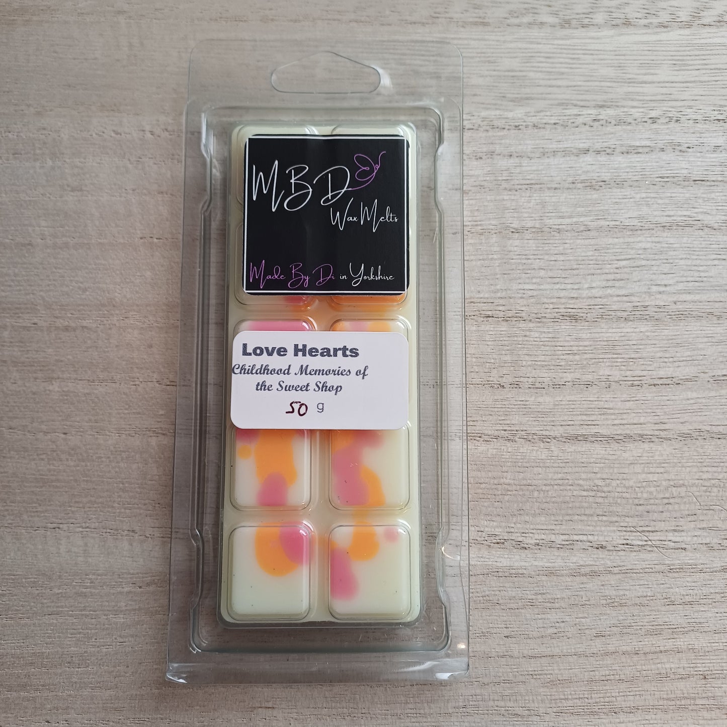 Packaged wax melts on a wooden surface