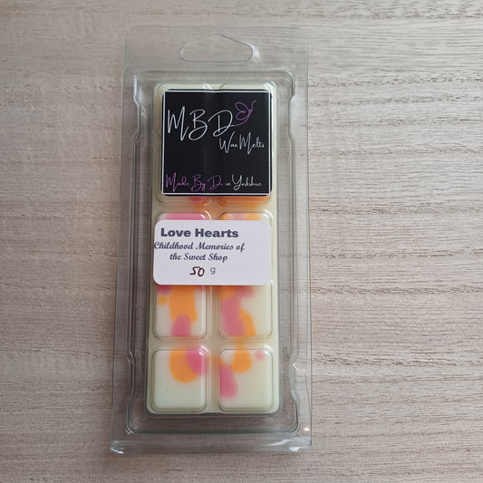 Packaged wax melts on a wooden surface
