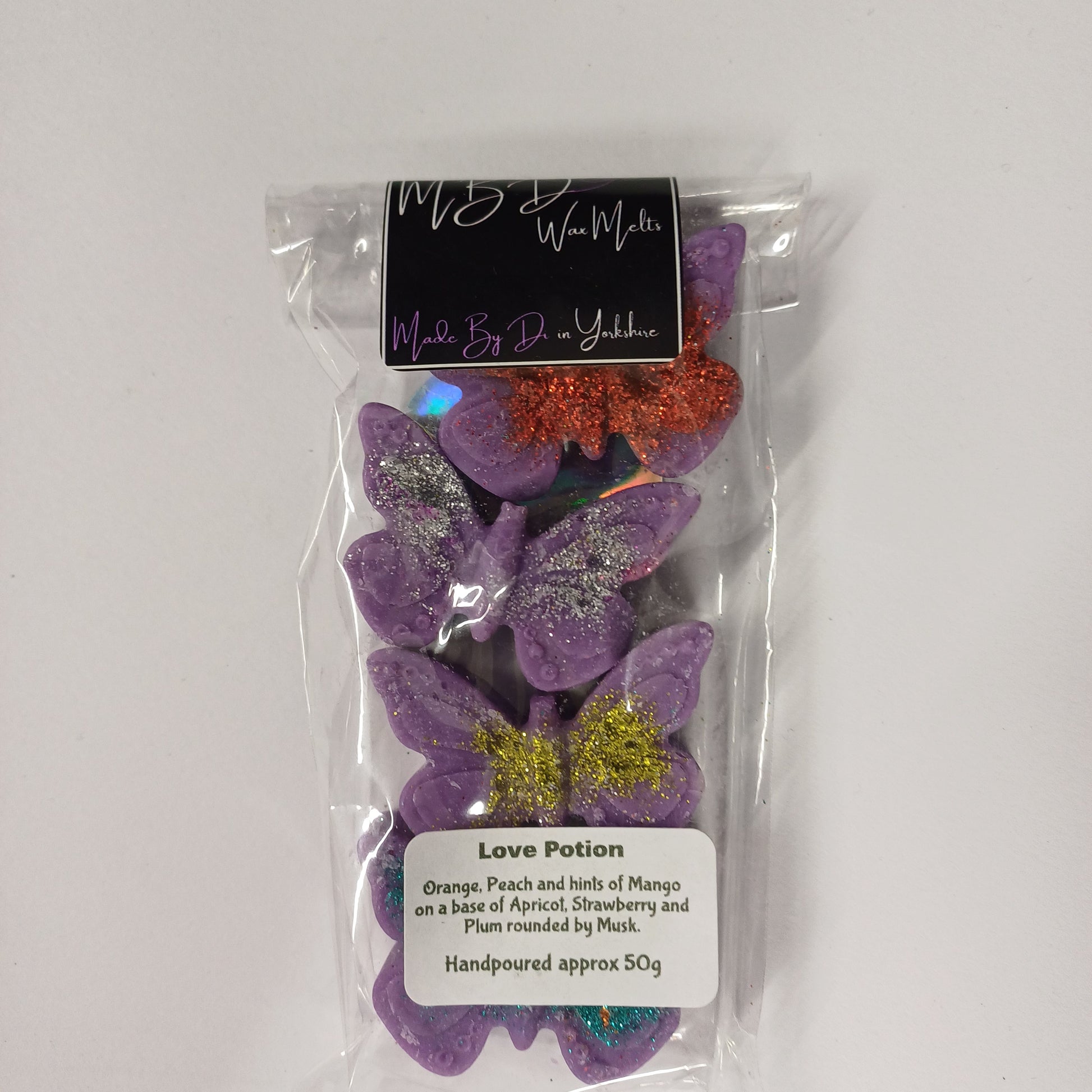 Packaged decorative purple  butterflies on a white background.