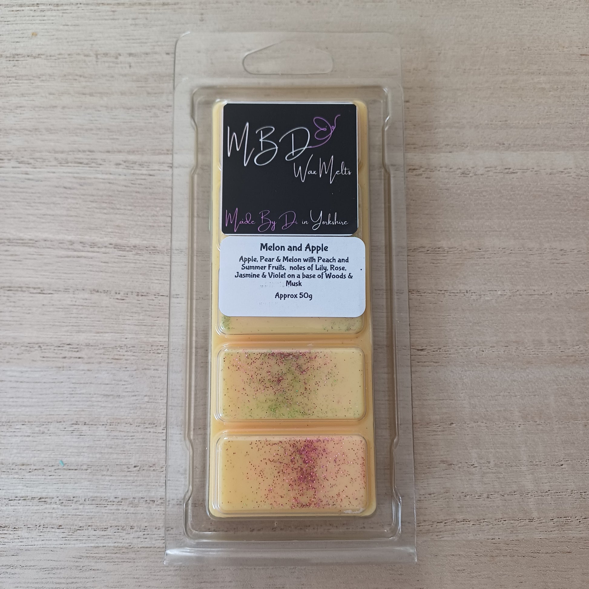 Wax Melt Bar in a clear package on a wooden surface