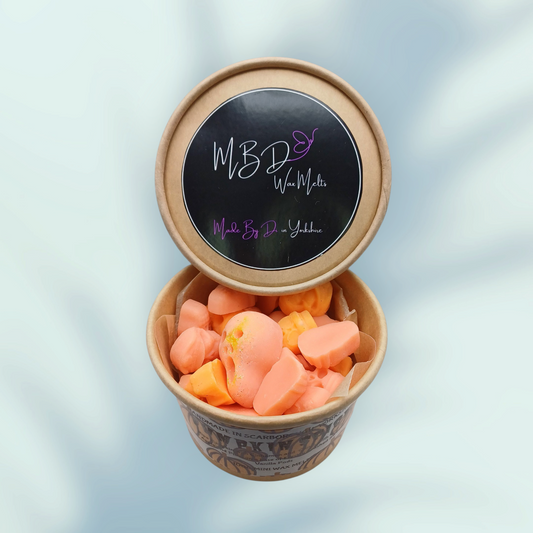 Open Container of orange mini wax melts