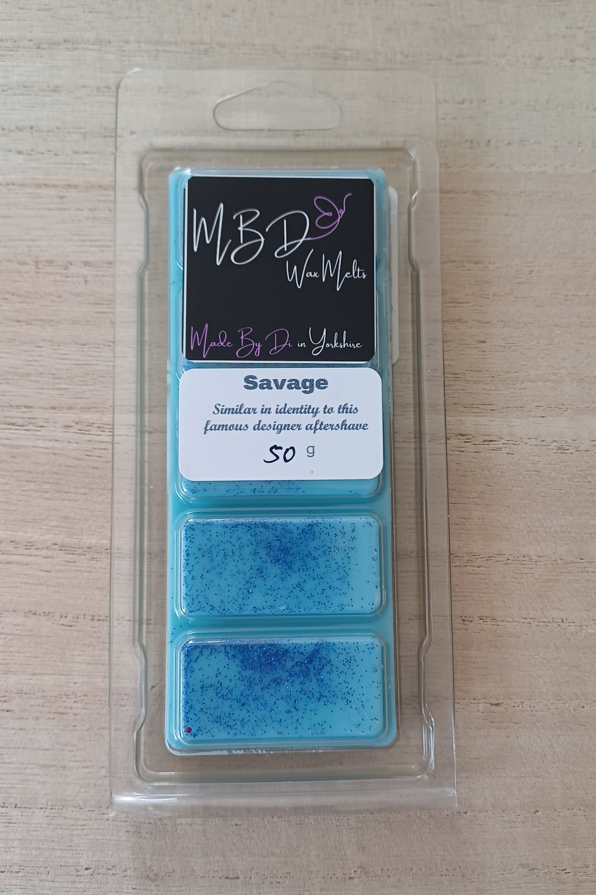 Packaged Blue wax Melt on a wooden surface
