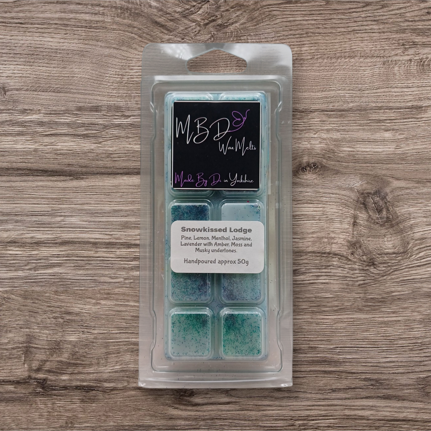 Packaged wax melts with a label on a wooden surface