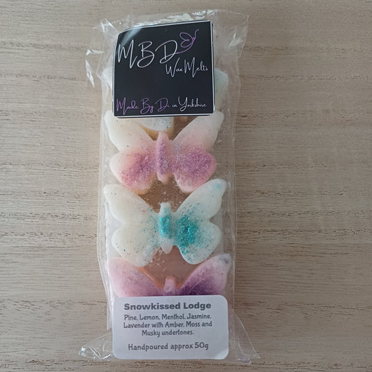 Packaged Butterfly Shaped Wax Melts with Visible Branding on a wooden surface