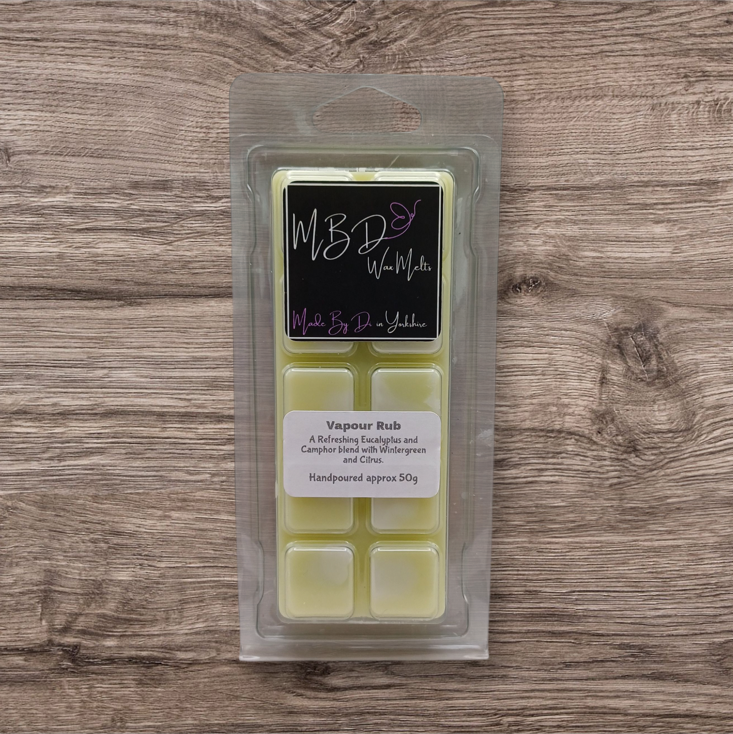 Packaged wax melts with a label on a wooden surface