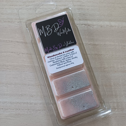 Packaged wax melt with a label on a light wooden surface